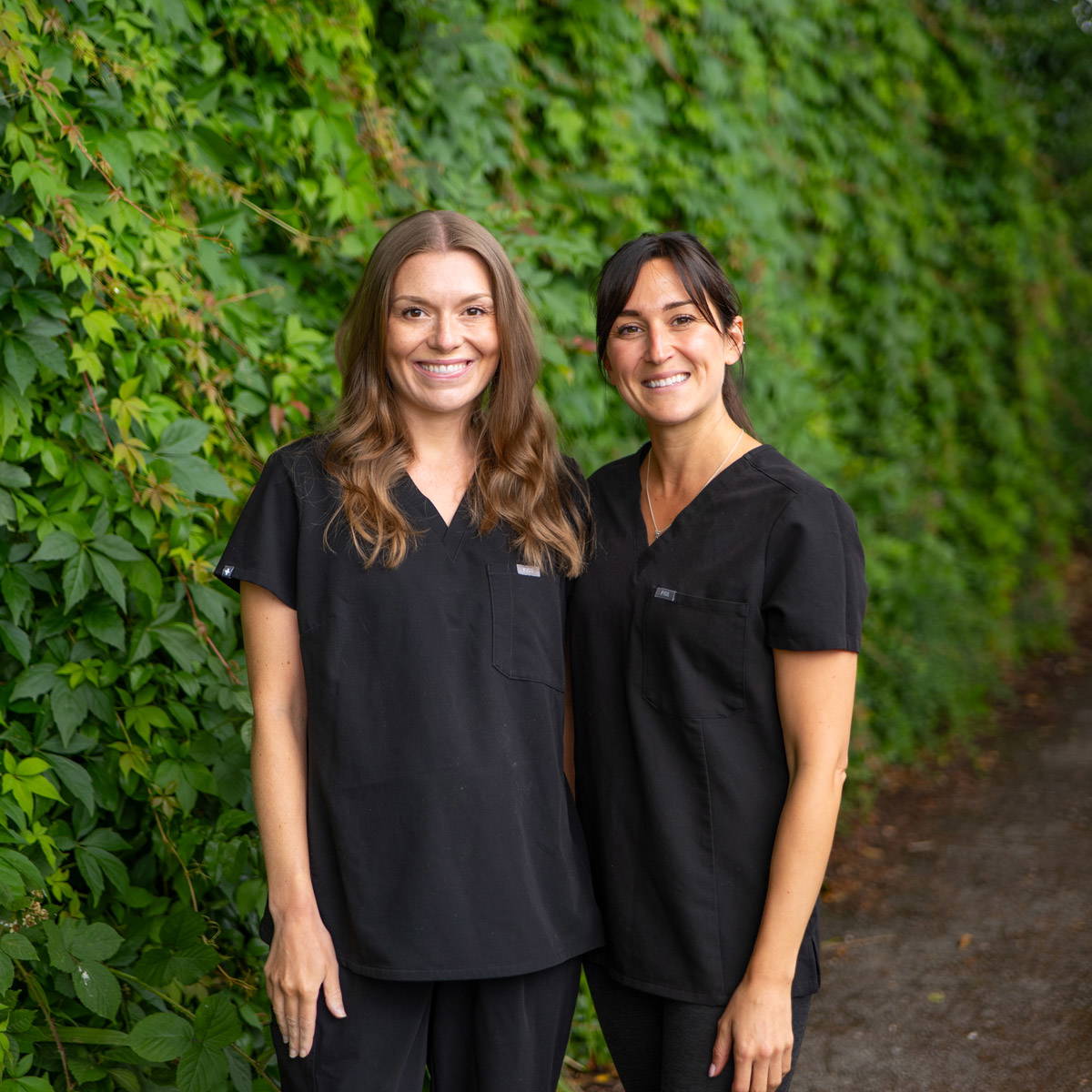 Francescca and Hannah the coulthard dental hygiene & gum health team stand outside the wilmslow dental practice